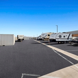 RVs and boat parked at storage facility