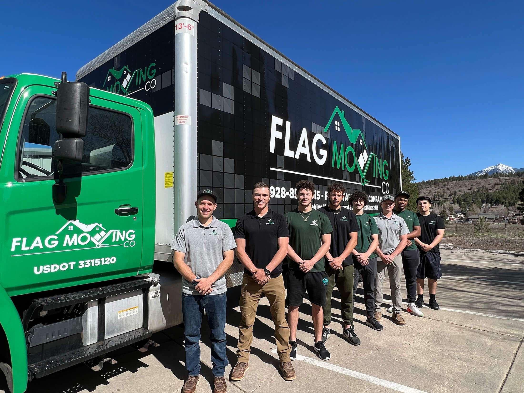 Employees beside moving truck