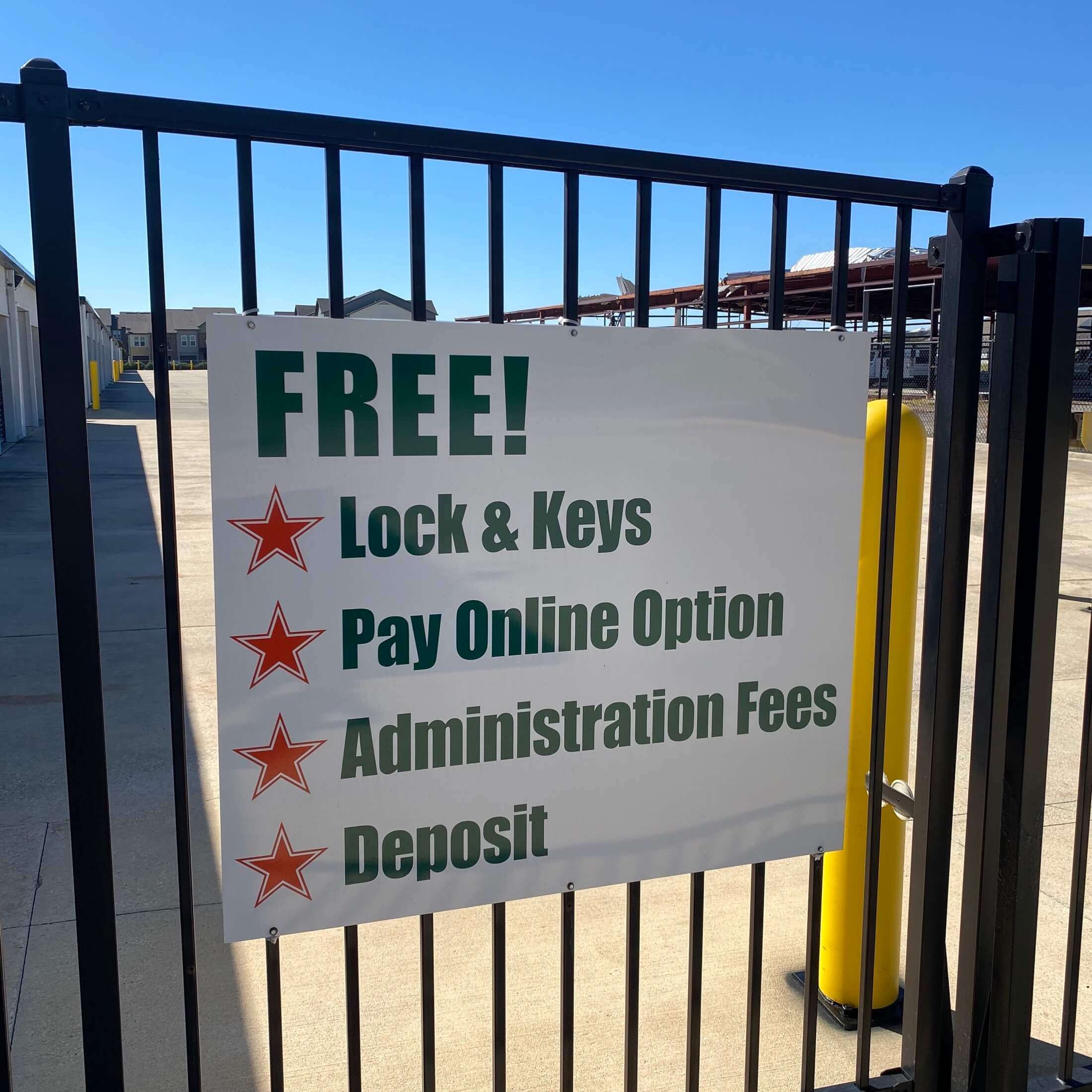Secure gate with sign at self storage buildings