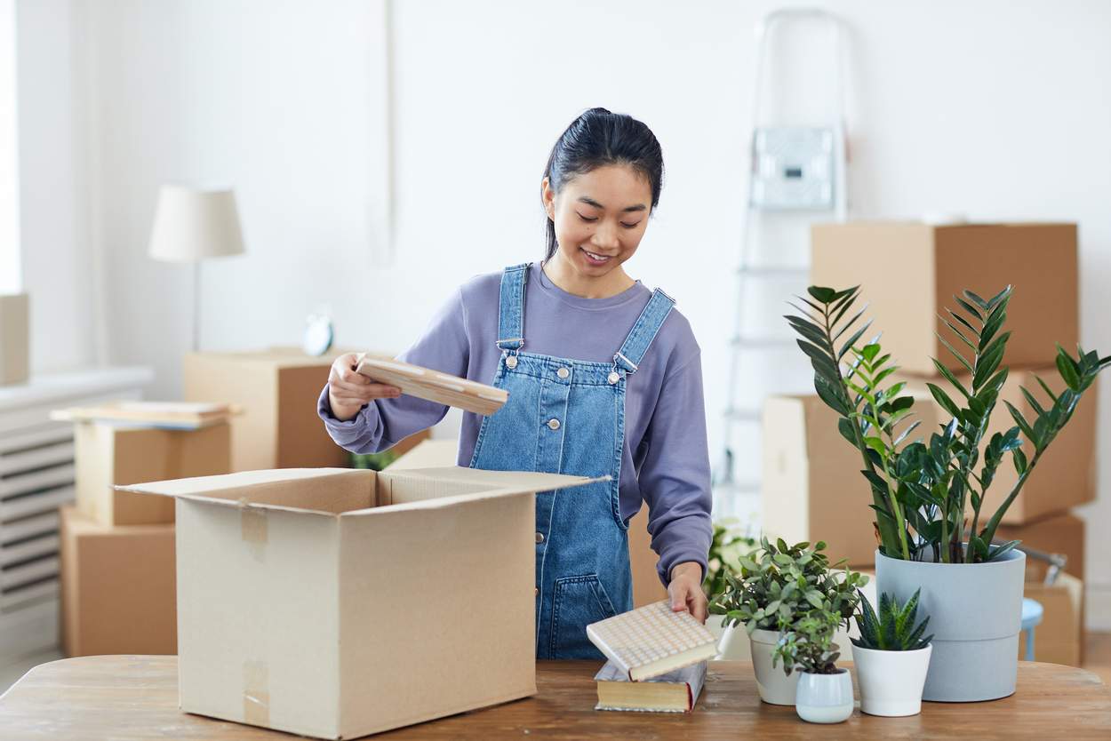 Student Packing Boxes in Dorm