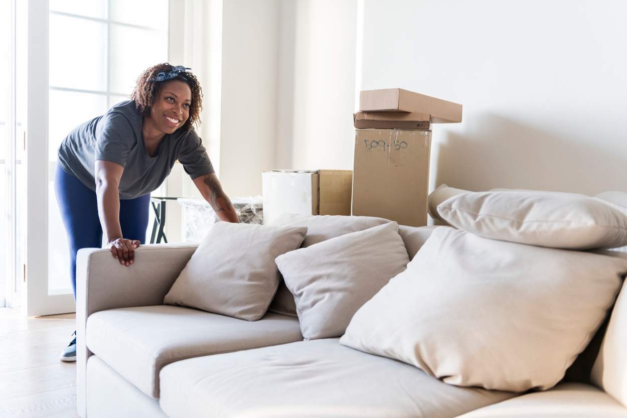 Couple moving furniture into new home