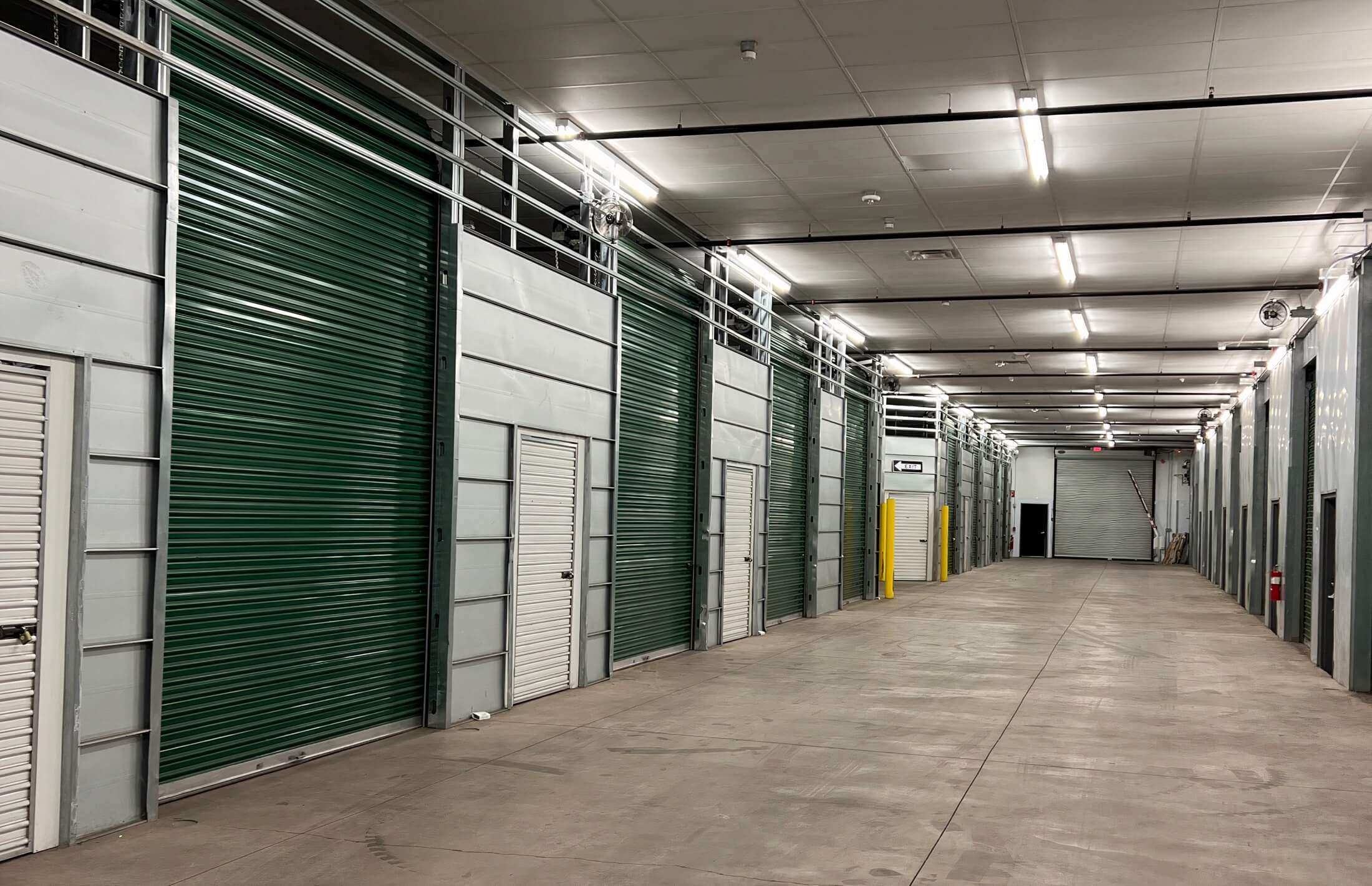 Wide aisle between rows of indoor drive up storage units