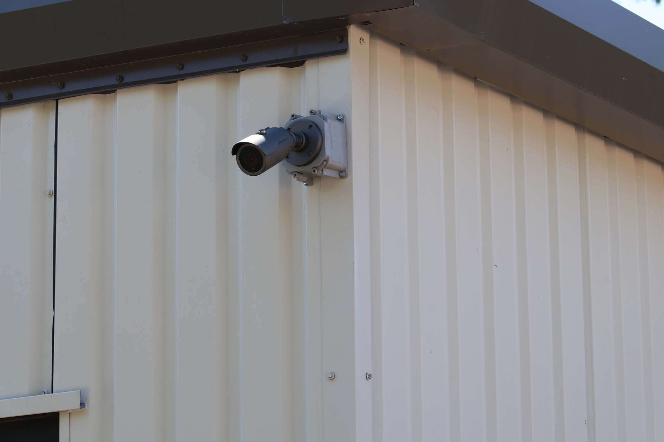 Security camera mounted on storage building